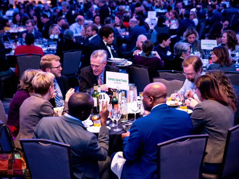 Photo of attendees seated at a round table during the Annual Dinner