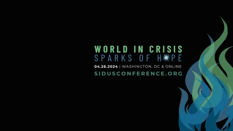 "WORLD IN CRISIS" in green above "SPARK OF HOPE" in blue with the "O" in HOPE replaced by a radiating white-blue spark. 3 superimposed graphics of flames in varying shades of green and blue on the righthand side.