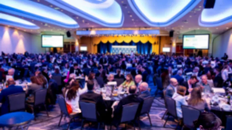 Blurred image of wide angle shot of ballroom with attendees seated at round tables