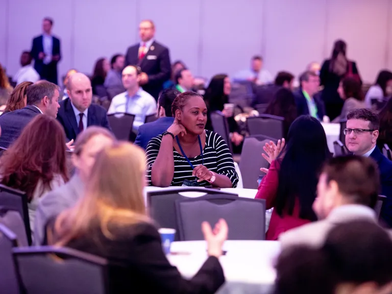 A crowd of people talking in an event space